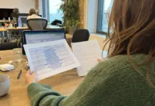 Gründerin prüft Fundraising-Unterlagen und Marktkennzahlen am Arbeitsplatz.