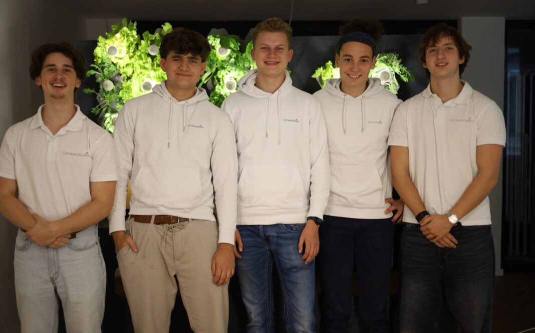 Das fünfköpfige Gründerteam von CompactGreens vor einer bepflanzten Wand